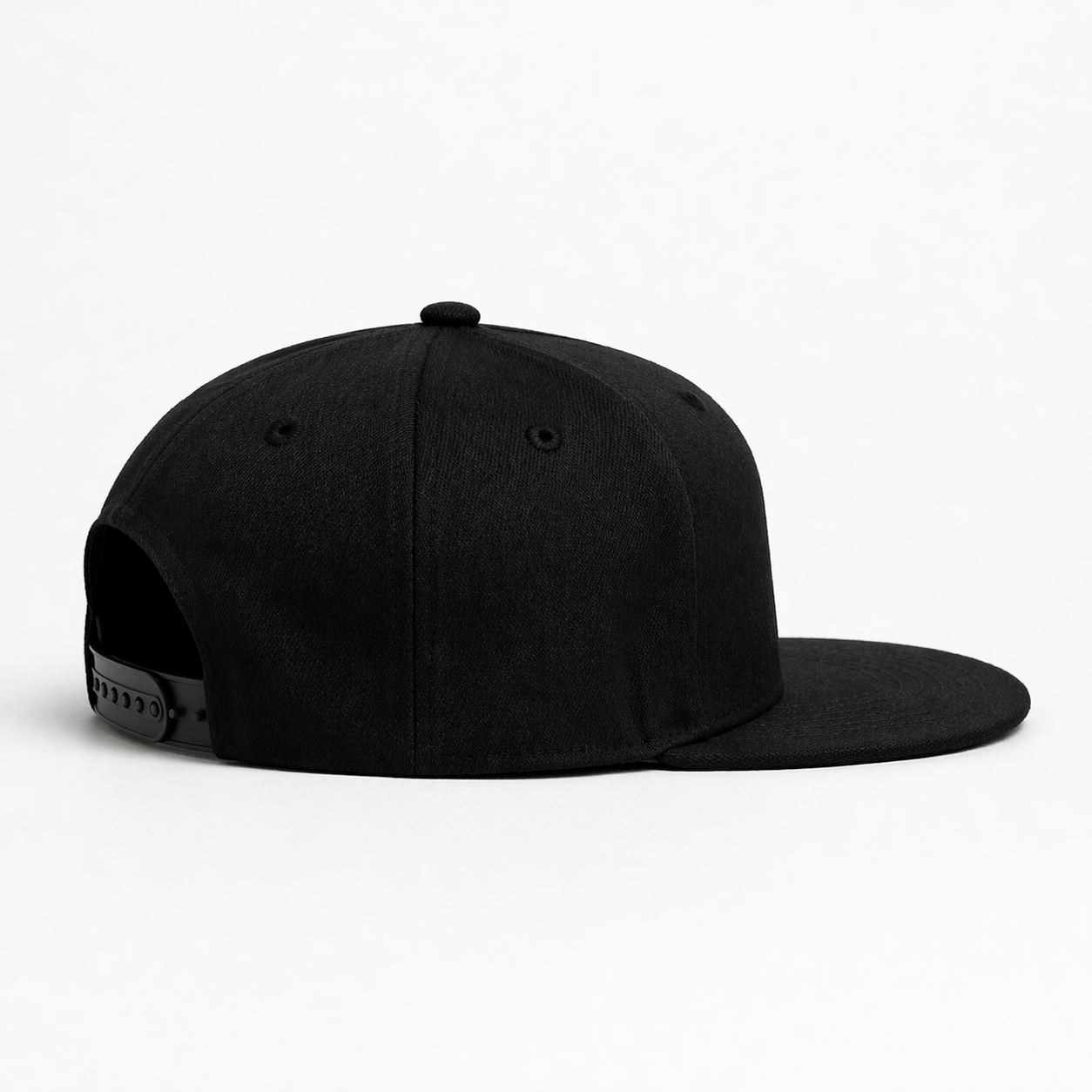 Black snapback hat side view on white background, flat brim, adjustable closure
