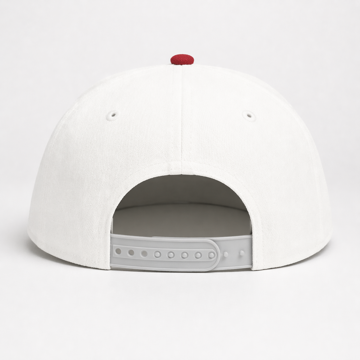 Back view of white adjustable snapback cap with red top button on white background