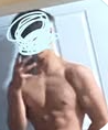 Shirtless person taking mirror selfie, head obscured, standing in front of white door.